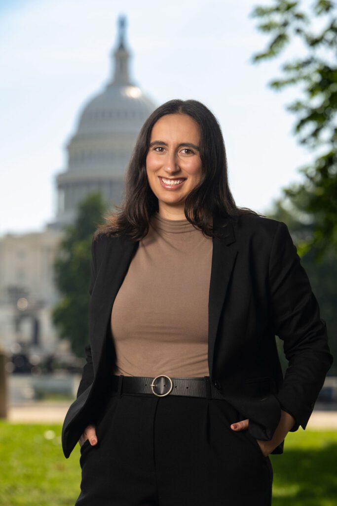 Professional headshot with US Capitol dome backdrop